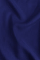 Dark blue knit fabric close-up with soft drape folds