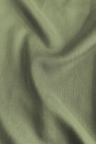 Olive green woven fabric close-up for maxi dress